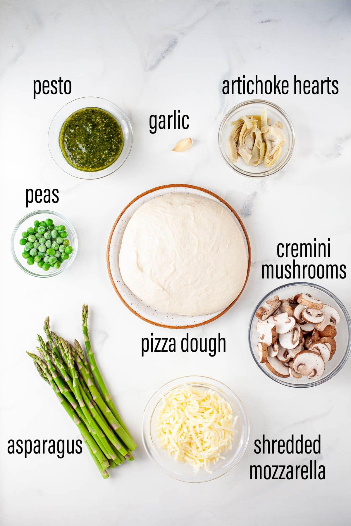 graphic of ingredients for spring pizza on marble surface with black text overlay.